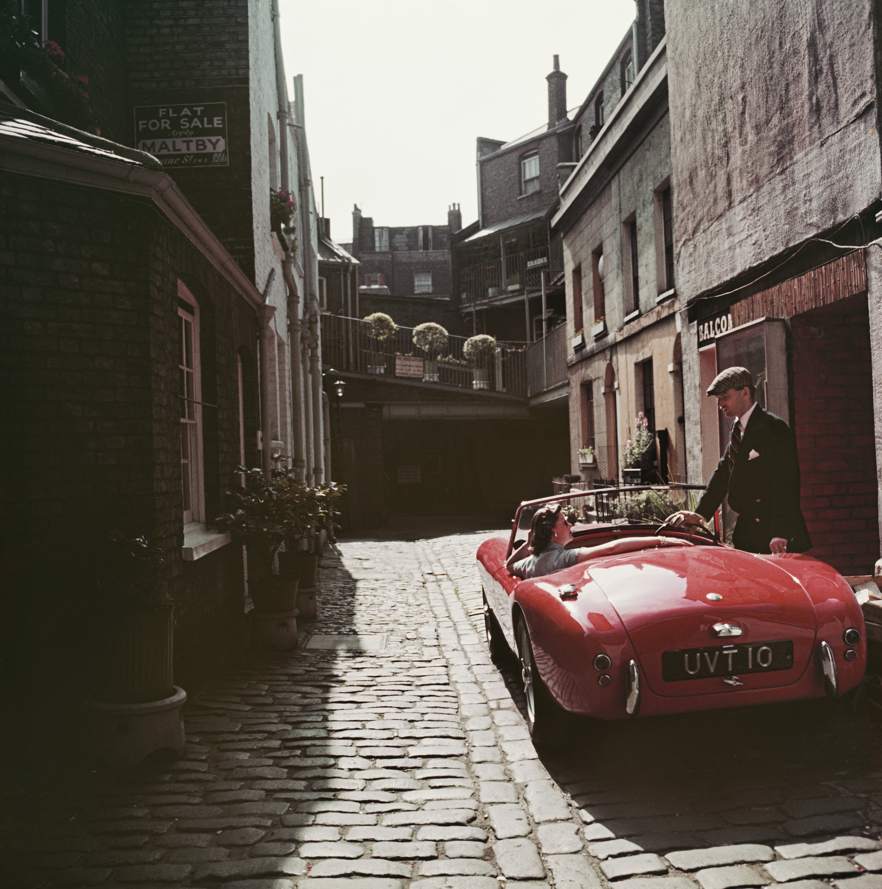 Sports Car Couple (London), 1955 by Slim Aarons